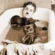 Charlie Chaplin sleeps in a bathtub in a scene from his 1922 film, Pay Day.